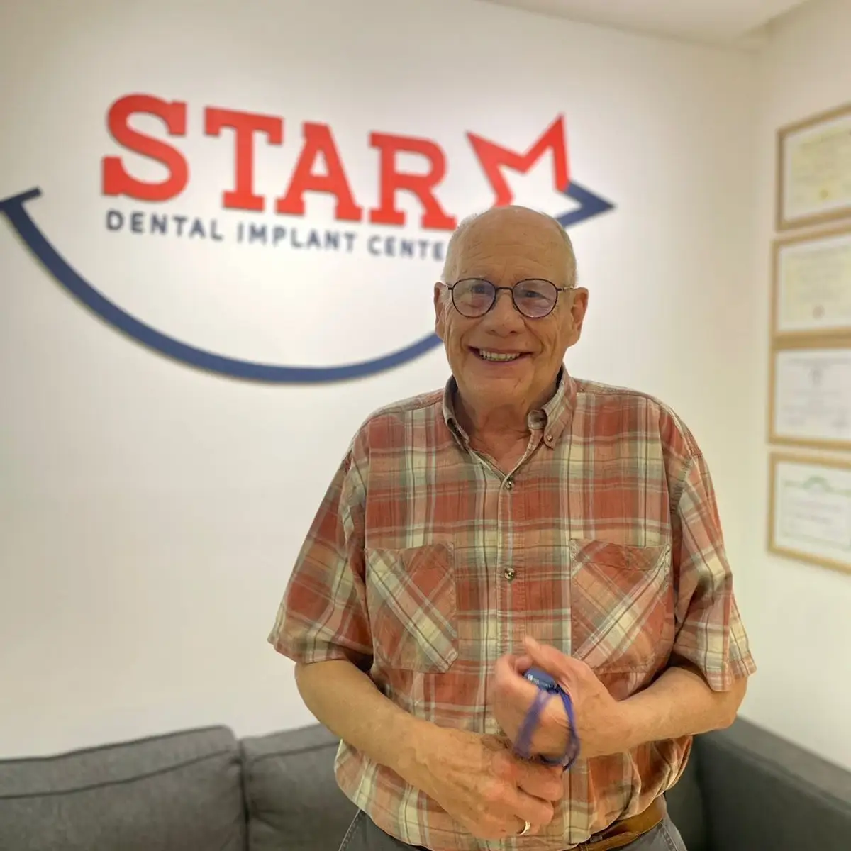 Senior male patient smiling after dental implant treatment